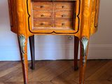 a small wooden table with drawers on it on a hard wood floor