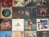 many different album covers on the wall of a room