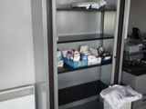 a tall bookcase with many items on it in a room