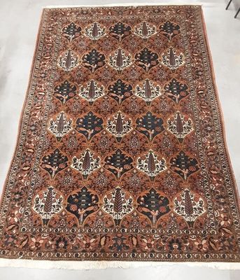 a brown and black rug with a floral design on it