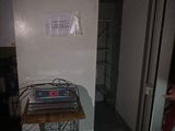 a small table with a laptop on it in the corner of a room