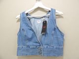 a close up of a denim vest on a hanger on a wall