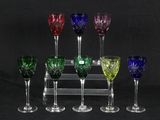 six wine glasses are lined up in a row on a black background