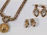 several pieces of jewelry including a necklace, earrings, and a ring