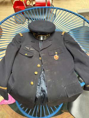 a coat and tie sitting on a chair in a room