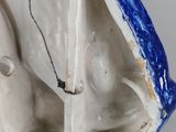 a white and blue vase with a bird on it