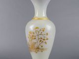 an image of a white and gold vase with flowers on it