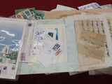 a pile of postcards and envelopes sitting on a table