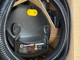 a box with a blower and a hose in it