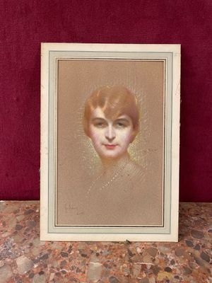 a painting of a woman ' s face is shown in a white frame