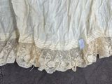 a close up picture of a bed skirt with a tag on it