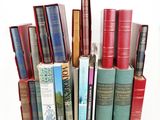 many books stacked on top of each other on a table