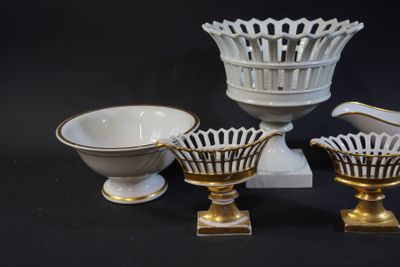 three white and gold vases and a bowl on a black background