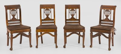 three wooden chairs sitting next to each other on a white surface