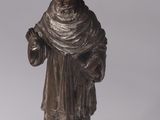 a statue of a man with a hat on a table
