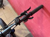 a close up of a bicycle handlebar with a red wall in the background