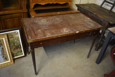 a table with a wooden top and a wooden cabinet in the background