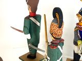 four toy soldiers that are on display in a room