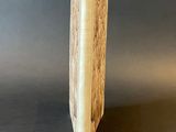 a small wooden object on a black surface