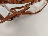 a close up of a bridle on a white surface with a white background