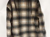 a close up of a jacket hanging on a wall on a hanger