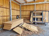several pieces of wood are stacked up in a shed