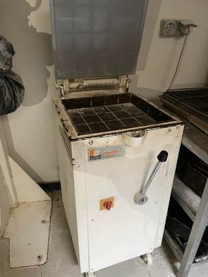 a man standing next to a stove in a kitchen
