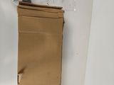 a cardboard box sitting on the floor next to a wall