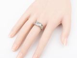 an image of a woman ' s hand with a ring on it