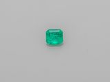 an emerald stone on a white surface
