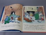 an open book with a picture of a group of animals on it