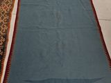 a blue rug on the floor next to a pile of blankets