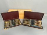 two wooden boxes with pens in them sitting next to each other