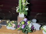 a vase of flowers sitting on a table next to rocks