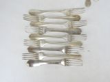 a lot of forks and spoons on the table