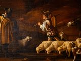 a painting of a man and a woman in a stable with sheep