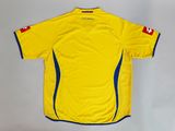 a close up of a yellow soccer jersey on a white background
