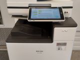 une imprimante blanche sur laquelle est posée une tablette