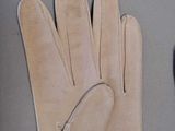 a pair of gloves sitting on a table next to a pair of scissors