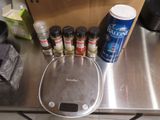 a scale with spices on it sitting on a kitchen counter