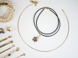several necklaces and bracelets are laid out on a white surface