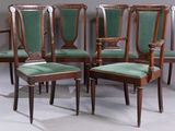 four chairs with green upholstered cushions and wood legs