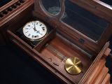 a clock in a wooden box on a black background