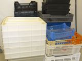 many plastic containers stacked on top of each other in a room