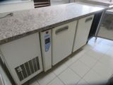 a picture of a kitchen with a refrigerator and a counter top