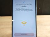 a close up of a cell phone on a wooden table