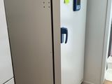 a white refrigerator in the corner of a room