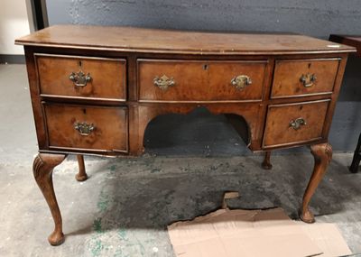 a wooden desk with drawers on it in a room