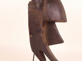 an image of a wooden sculpture of a helmet on a stand