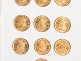 a lot of gold coins sitting on a white surface